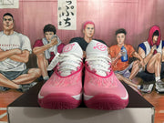 Front view of magenta and white Nike basketball shoes with white laces