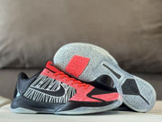 Side view beside the outsole, showing the patterned tread and red details