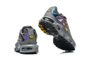 Heel and outsole views of Nike Air Max Plus sneakers in dark grey with colorful accents