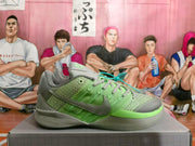 Side view of a grey and green Nike Kobe basketball shoe