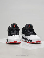 Front three-quarter view showing the white toe panels, black uppers, and red outsole accents.