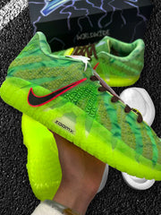 Close-up side view showing the neon green sole, green upper, black swoosh, and red outline.