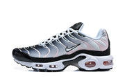Side view of Nike Air Max Plus sneakers showing the grey and pale pink wavy upper and cushioned midsole