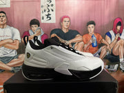 Side profile of a white and black Jordan sneaker showing the textured upper, padded collar and visible heel unit.