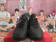 Front view of black Nike sneakers showing padded tongues, black laces, and textured toe panels.