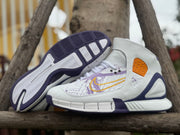 Pair of white and purple high-top basketball shoes with map graphics, shown with the outsole visible
