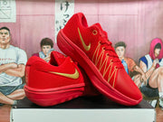 Pair of red and gold Nike basketball shoes shown from side and top angles