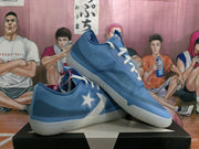 Angled view of blue basketball sneakers showing the side detail, textured upper, and translucent-looking outsole.
