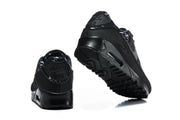 Rear and outsole views of a black Nike Air Max 90 sneaker with patterned heel lining.
