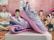 Angled view of a pair of lavender and pink sneakers with patterned laces