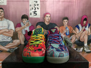 Front view of the mismatched pair, showing the red-and-green shoe beside the blue, purple and gray shoe.