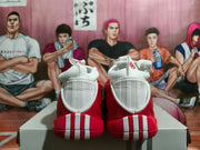Rear view showing the white heel details on red basketball shoes
