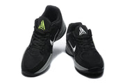 Pair of black Jordan sneakers shown from the front, with white and bright yellow tongue and side accents.