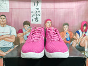 Front view of the pink and white Nike basketball sneakers with pink laces, textured toe boxes, and white midsoles.