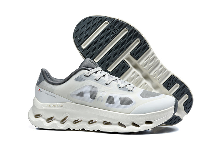 White and grey On Cloudtilt Remix sneakers shown from the side and underneath