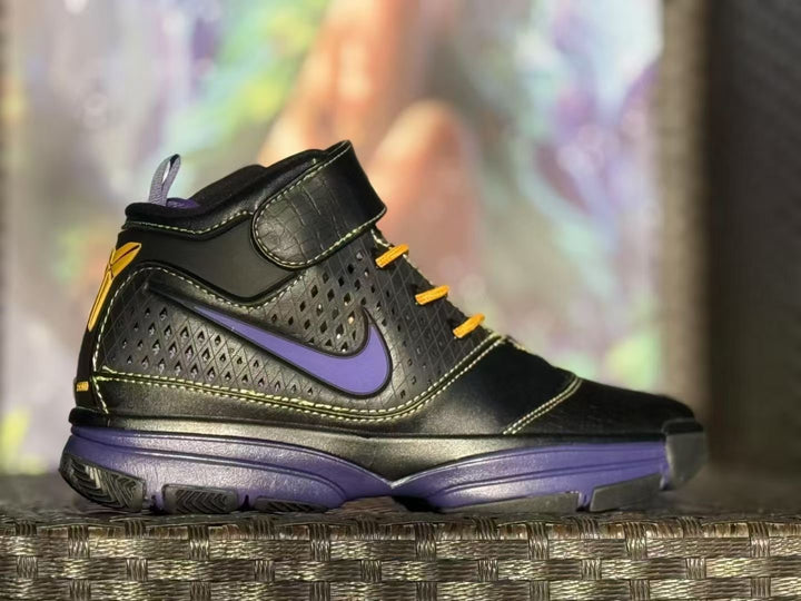 Side view of a black high-top sneaker with purple accents, yellow laces, and a padded ankle strap.