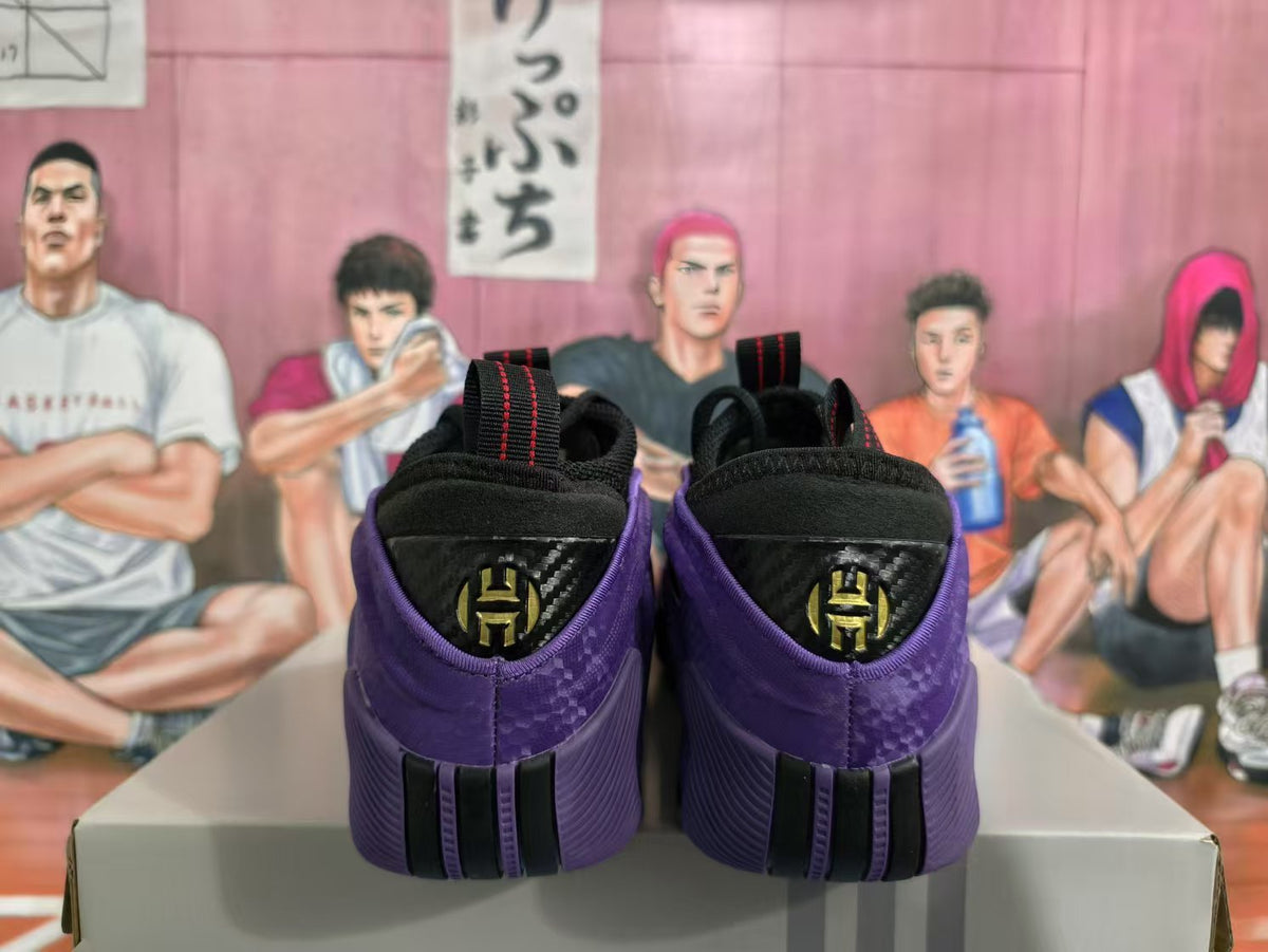 Rear view of black and purple basketball sneakers showing the pull tabs and heel detailing.