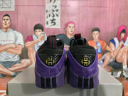Rear view of black and purple basketball sneakers showing the pull tabs and heel detailing.