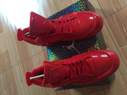 Top-down close view of red high-top sneakers with padded tongues and mesh toe panels.