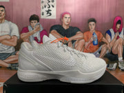 Side view of a white Nike basketball sneaker showing the textured upper, sculpted heel and rubber outsole.