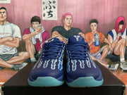 Front view showing dark blue laces, graphic toe panels, Nike basketball branding, and translucent light blue outsoles.