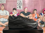Pair of black basketball sneakers shown in side view on a shoebox, with visible Air Zoom marking and Jumpman branding.