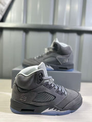 Side view of a grey high-top sneaker showing the ventilated side panel, number 23 detail, layered upper, and translucent outsole.