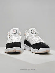 Front view of white and black Jordan high-top sneakers with pink accents and Jumpman tongue logos.