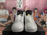 Front view of white high-top sneakers with black tongue details