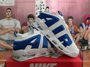 Angled side view of the white and blue Nike sneakers displayed together, highlighting the layered upper and visible cushioning elements.