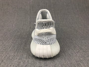 Rear view of the white and grey sneaker showing the padded collar, heel area and ribbed sole.
