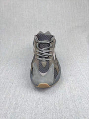 Top-down view of the gray sneaker showing the laces, tongue, toe box, and layered upper.