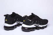 Pair of black and white Nike TN-10 sneakers viewed from the rear and side.