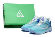 Aqua-blue and white Nike basketball shoes beside a green shoebox