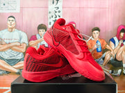 Angled view of red Nike basketball shoes showing the patterned sides and outsole