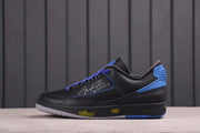 Side profile showing the black textured upper, blue heel details, purple laces, and signature-style side graphic.