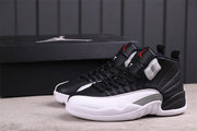 Three-quarter product view of the paired sneakers beside a black Jordan shoebox.