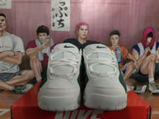 Front view of the white and dark green Nike sneakers showing the laces, tongues, and toe areas.