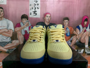 Front view showing perforated toe panels and pale yellow laces on Nike basketball shoes