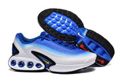 Blue and white sneakers shown with the outsole and cushioning details