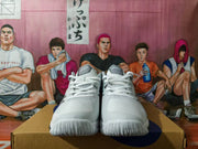 Pair of white and black ASICS basketball sneakers, viewed from the front