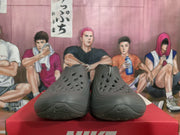 Front view of smoke gray Nike sneakers showing the perforated forefoot and side Swoosh details.