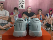 Rear view of the blue Nike sneakers showing perforated heel panels, heel branding, and textured rubber outsoles.