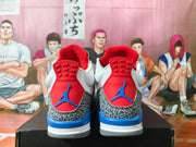 Rear view of white sneakers with red heel panels, blue accents, and elephant-print overlays.