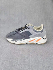 Side profile highlighting the sculpted white midsole and orange accent details.