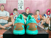 Rear view of turquoise Nike basketball shoes with gold-tone heel units