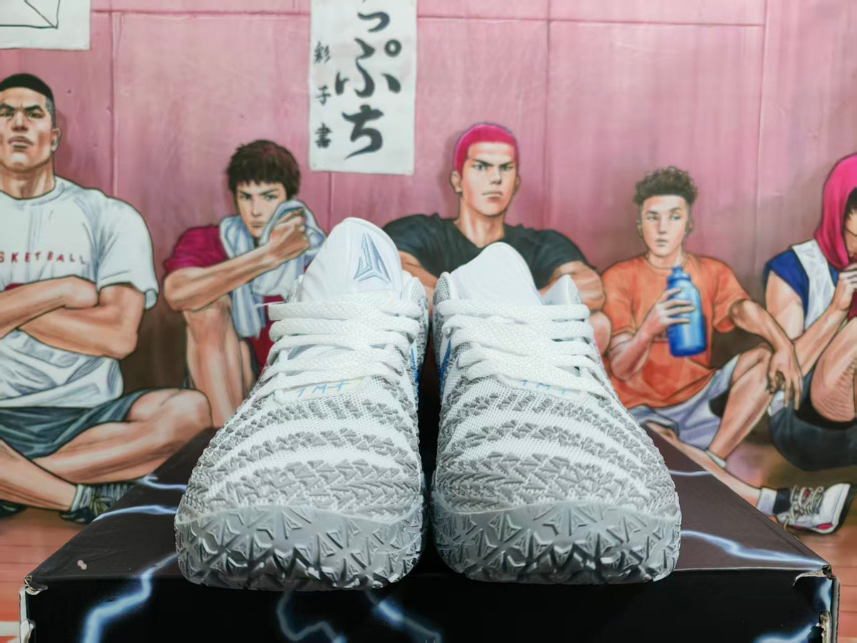Pair of white and gray low-top basketball shoes shown from the front, with textured uppers and patterned outsoles.