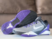 Outsole and side view showing the purple and black geometric tread pattern.