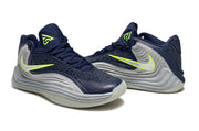 Pair of navy and gray Nike Giannis Immortality 7 basketball shoes from an angled view