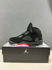 Single black Jordan Air Jordan 5 sneaker shown in side profile on a shoebox
